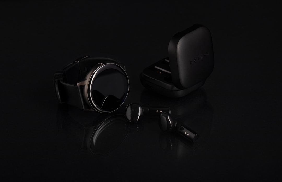 a-pair-of-headphones-and-ear-buds-on-a-black-surface-nnpi1n-8dg